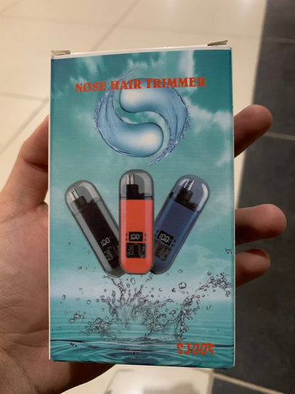 Nose hair trimmer packaging held in a hand with a water splash design.