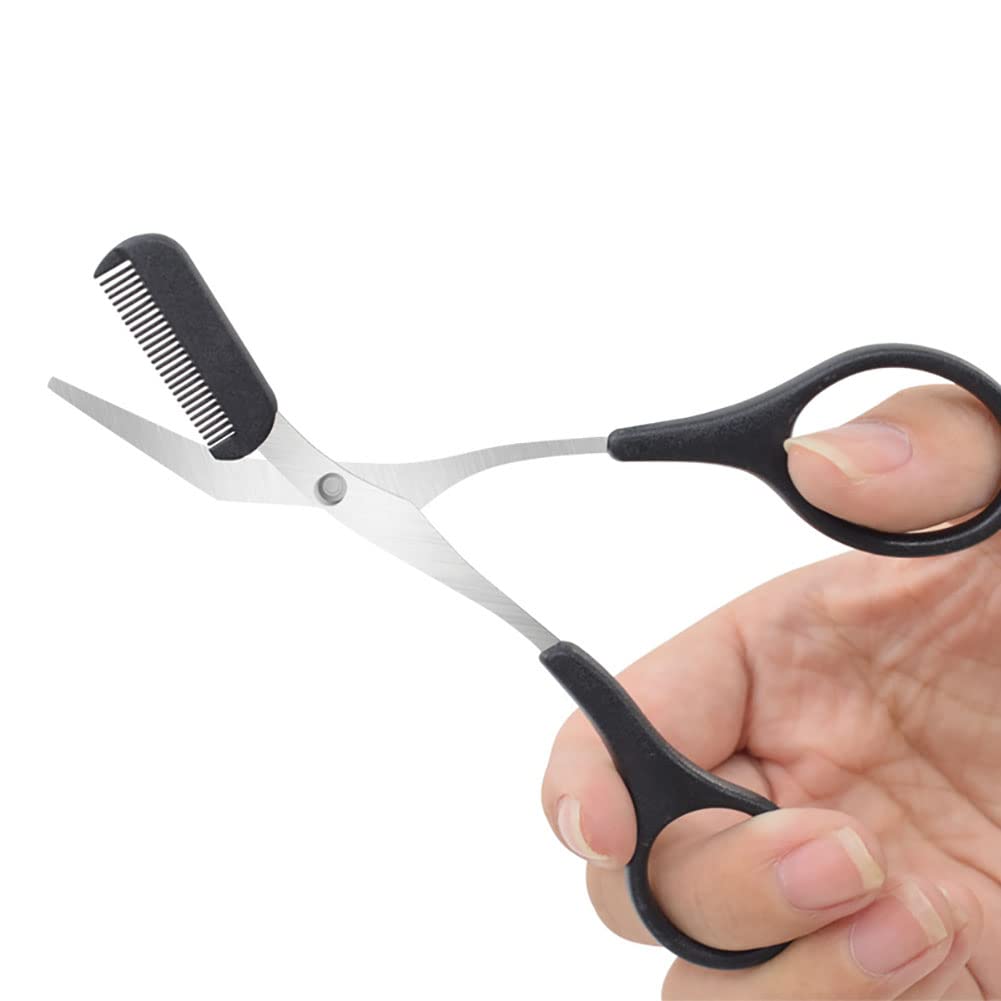 Hand holding a pair of black-handled scissors with a comb attachment on a white background