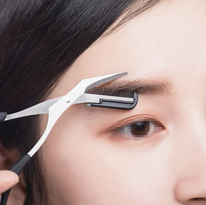Person using scissors to trim eyebrow with a comb