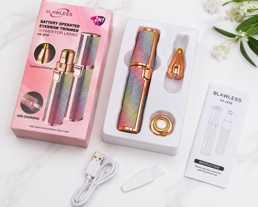 A battery-operated eyelash shaver for ladies by Blawless, shown with its pink retail box, white storage tray, USB charging cable, and instruction card on a light marble surface.